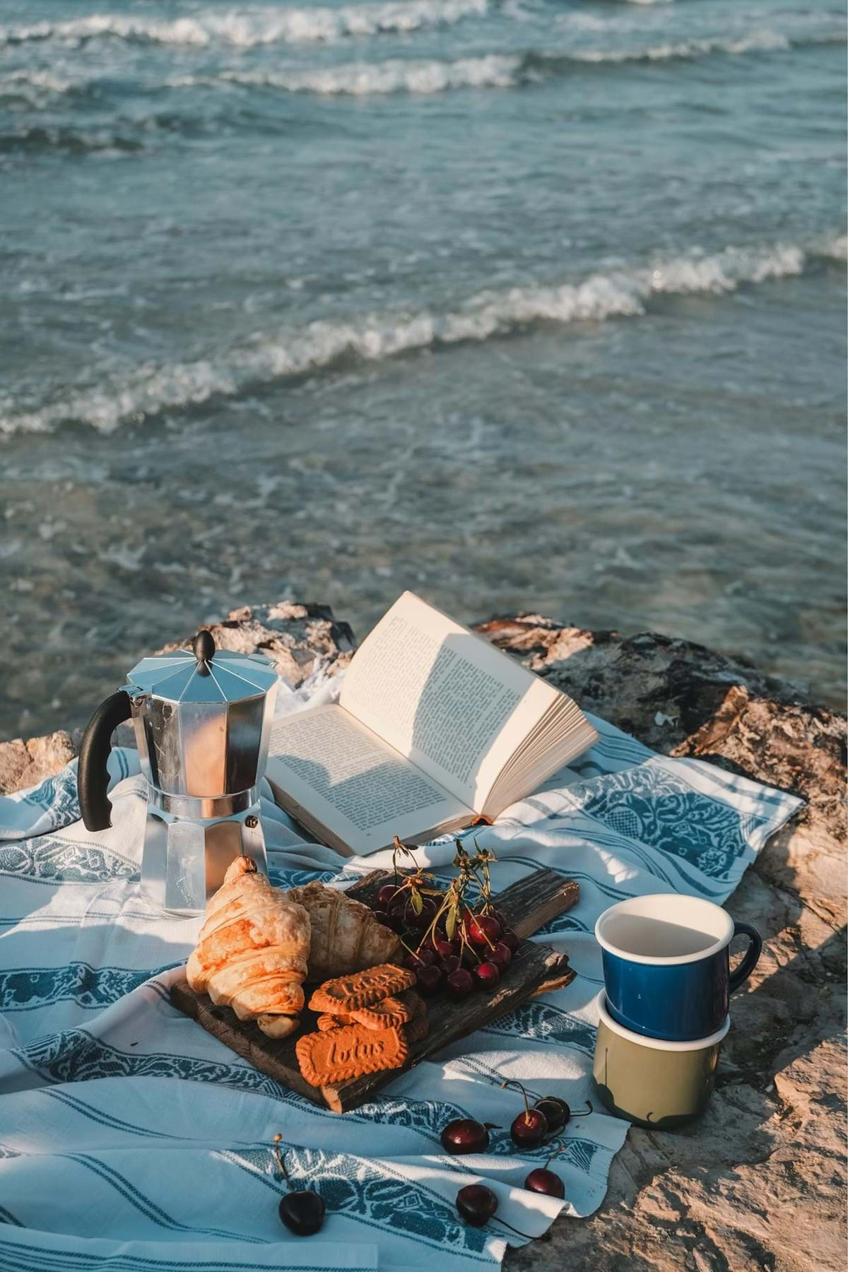 PIcnic on a beach with coffee and croissants